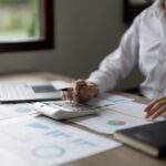 Business woman using calculator for do math finance in office, tax, accounting, statistics and analytic research concept.